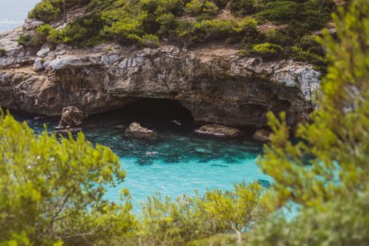 Discover the stunning turquoise waters and rocky cliffs of this serene sea cave location.