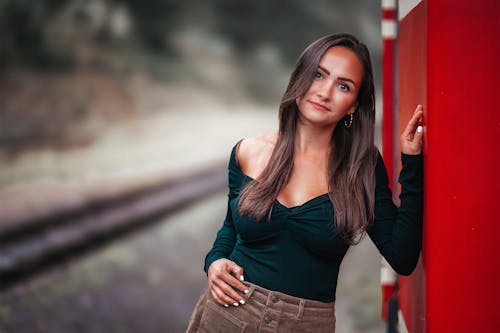 Model in a Green Blouse and Corduroy Pants by the Railway Tracks