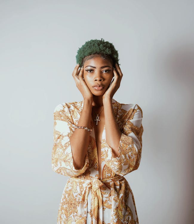 Photo of Standing Woman With Green Hair With Both Hands on Face Dressing Style