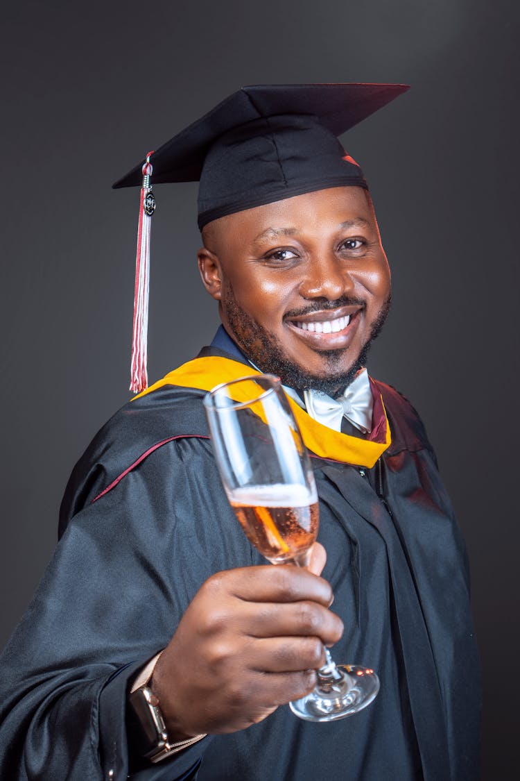 Portrait Of Graduate Student With Glass Of Champagne 