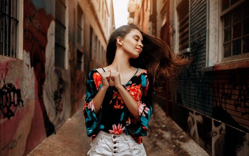 Woman Standing in Between Buildings