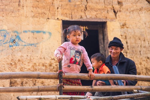 Man with His Children in Front of a Building 