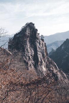 Majestic rock formation in Yangyang, South Korea, showcasing nature's raw beauty against a winter landscape.
