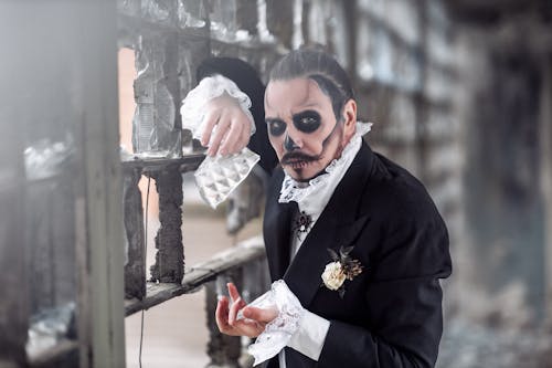 Man Wearing a Halloween Groom Costume and Skull Makeup 