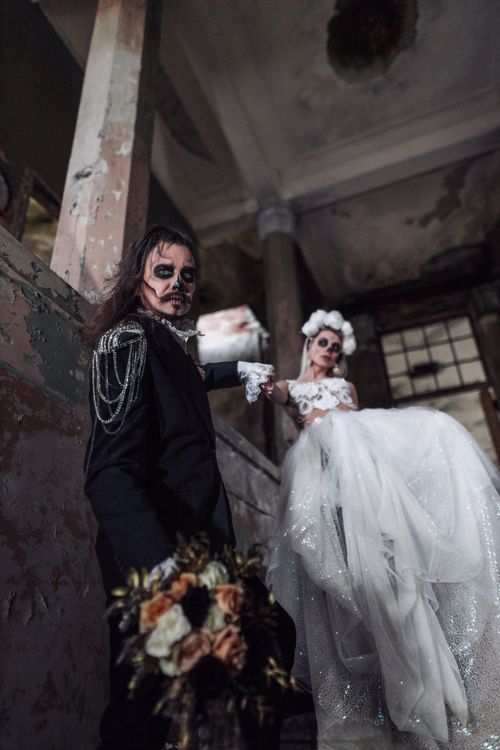 Free A couple in a Santa Muerte themed wedding, featuring gothic attire and makeup. Stock Photo