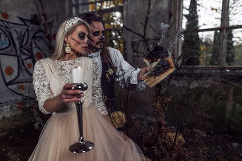 Man and Woman in Bride and Groom Halloween Costumes 