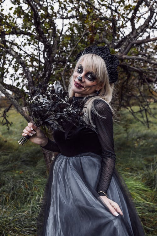 Woman Wearing a Halloween Costume and Makeup and Standing Outside 