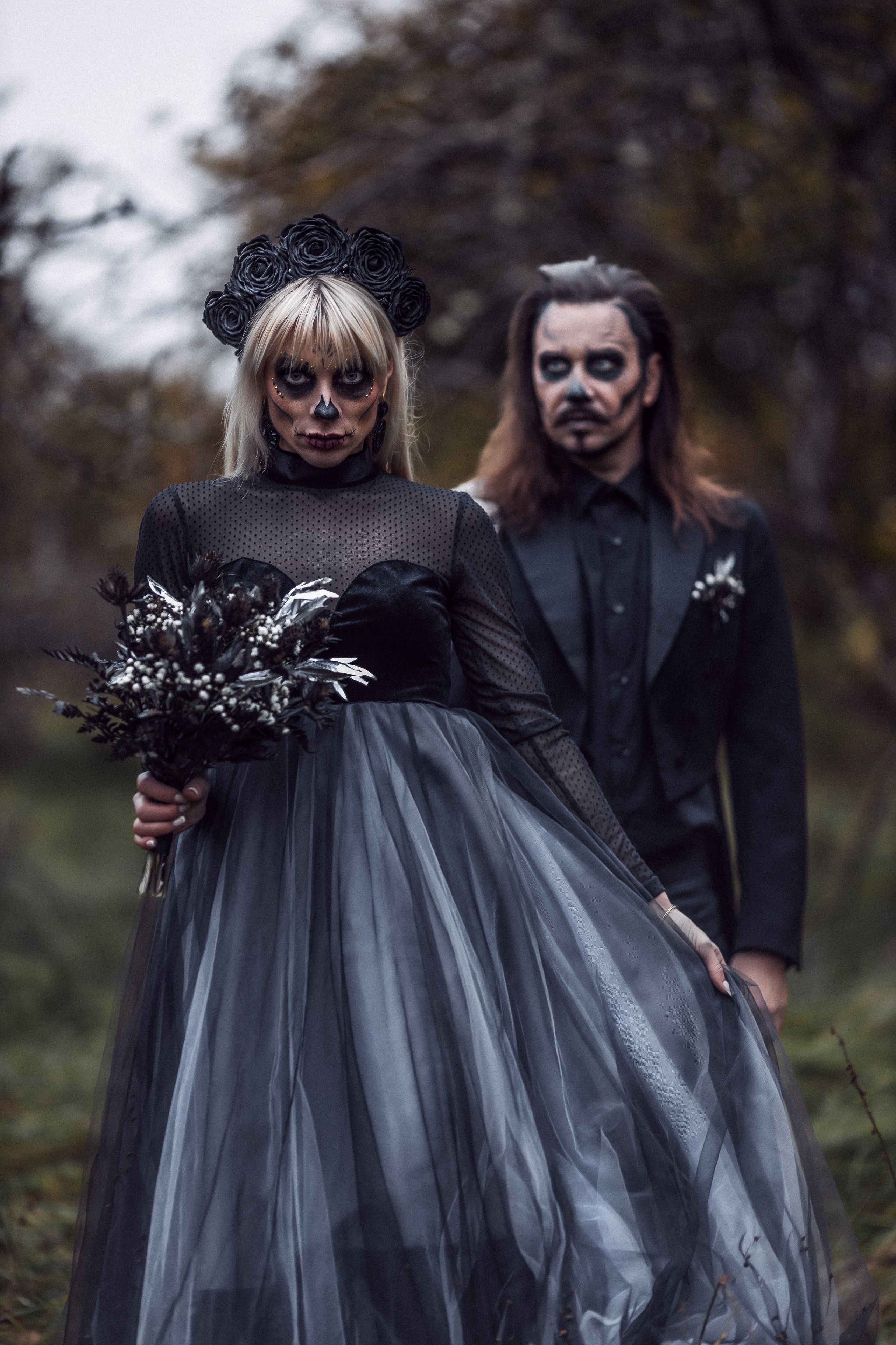 Man and Woman in Black Halloween Costumes and Makeup Standing Outside ...