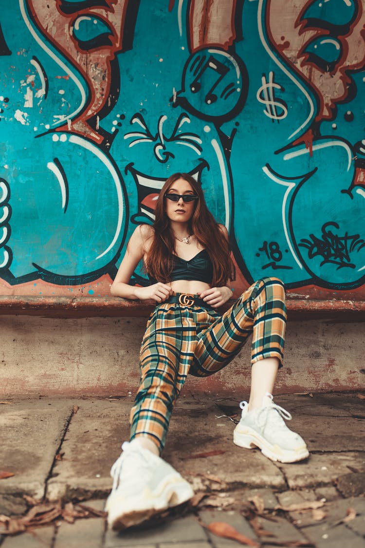 Woman Leaning On Graffiti Wall