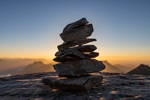 Stack of Stones on a Rock at the Top of the Mountain