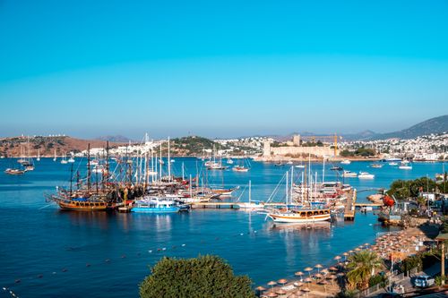 Free A stunning view of Bodrum's marina with sailboats and the historic Bodrum Castle on a sunny day. Stock Photo