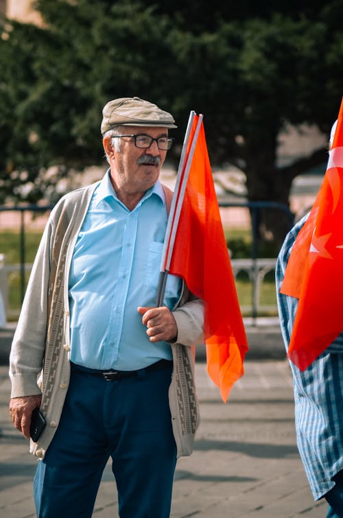 Elderly man Holding Turkish Flags
