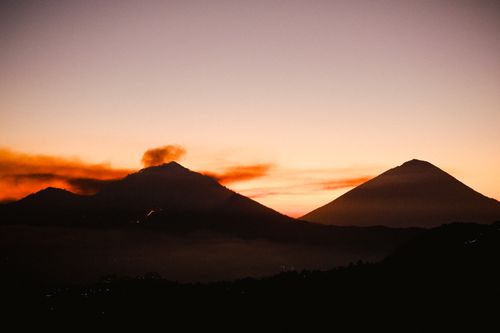 Free Dramatic silhouette of hills under a vibrant sunset sky. Perfect for landscapes. Stock Photo