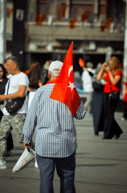 Back View of a Man Carrying a Flag 