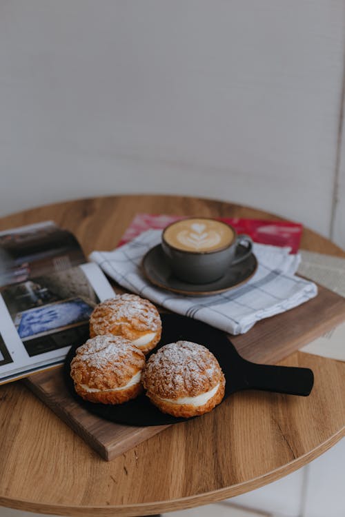 Cakes and Coffee Served on a Table 