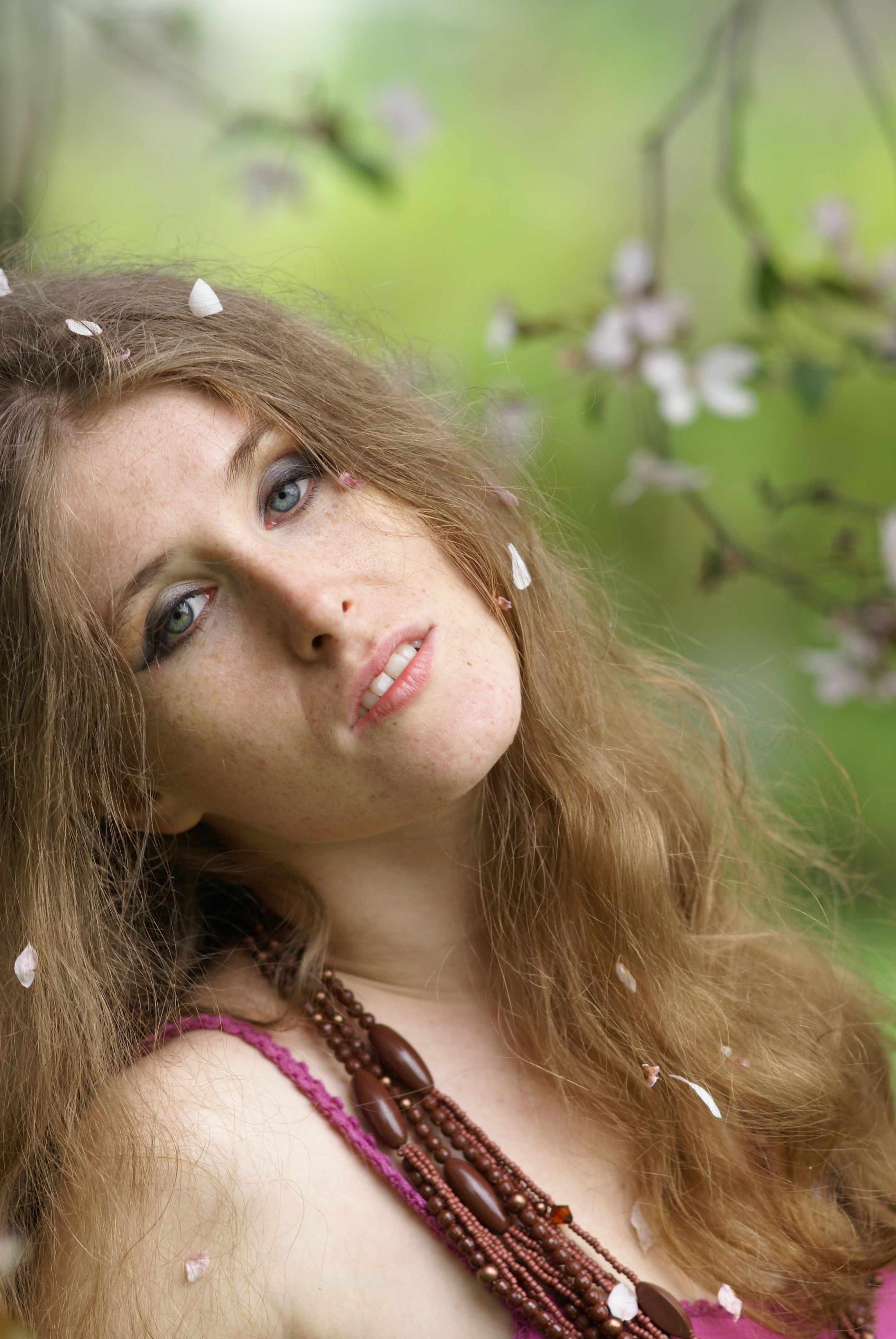 A woman with long hair and pink dress in the spring · Free Stock Photo