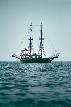 A sailing ship with masts and Turkish flag on a calm ocean, ideal for travel and tourism themes.