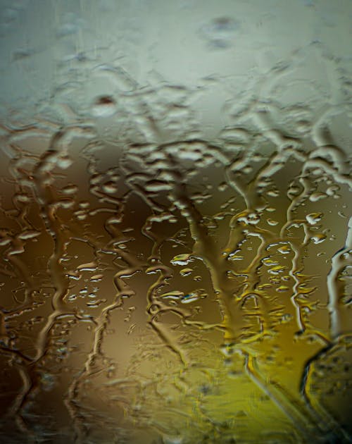 Water Flowing Down the Window Glass