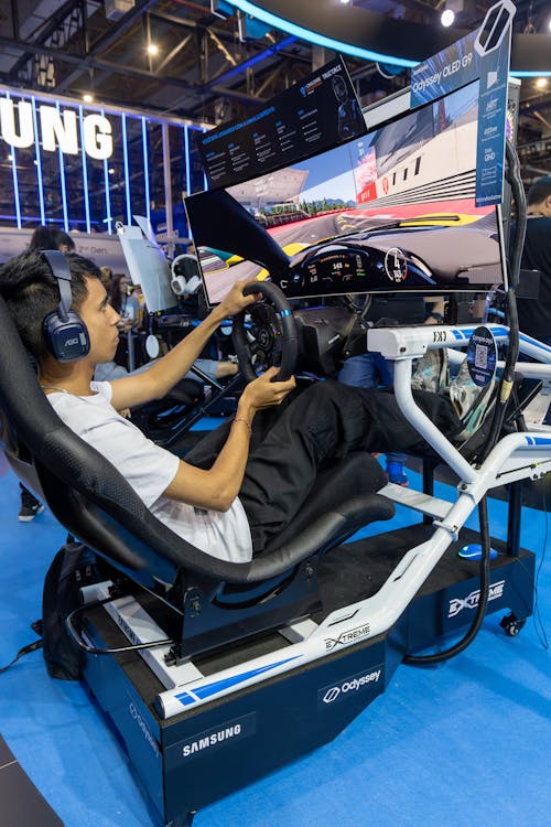 Boy Playing a Racing Game on a Racing Simulator 
