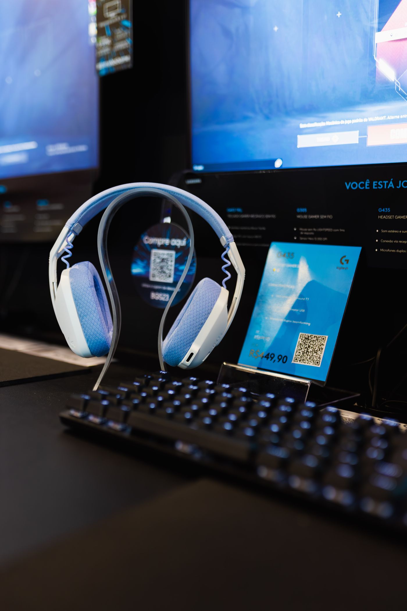 Gaming audio setup with headset illuminated keyboard and dual gaming monitors