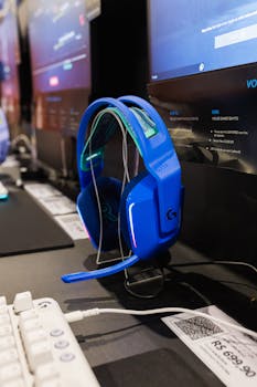 A bright blue wireless gaming headset displayed at an electronics trade show. Ideal for technology enthusiasts.