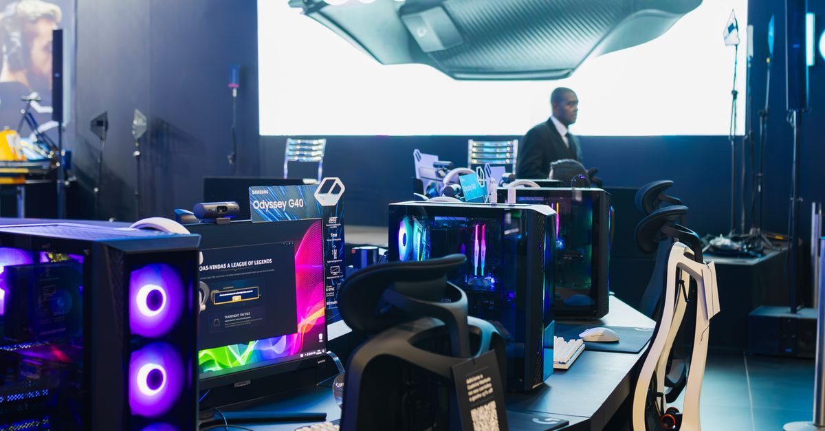 Gaming Computer Operator Computer Stations for Gamers Next to a Large Screen Displaying an ...