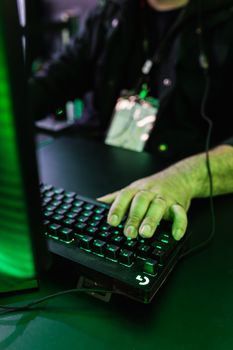 Close-up of a person gaming with a mechanical keyboard and mouse setup.