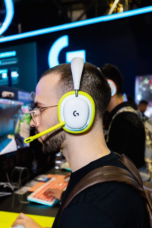 Man Wearing Headphones Playing on Computer 