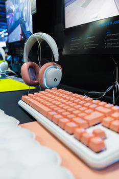 Stylish gaming setup featuring a pink mechanical keyboard and wireless headset