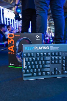 Astro A30 headset and Logitech keyboard showcased at a technology trade event.