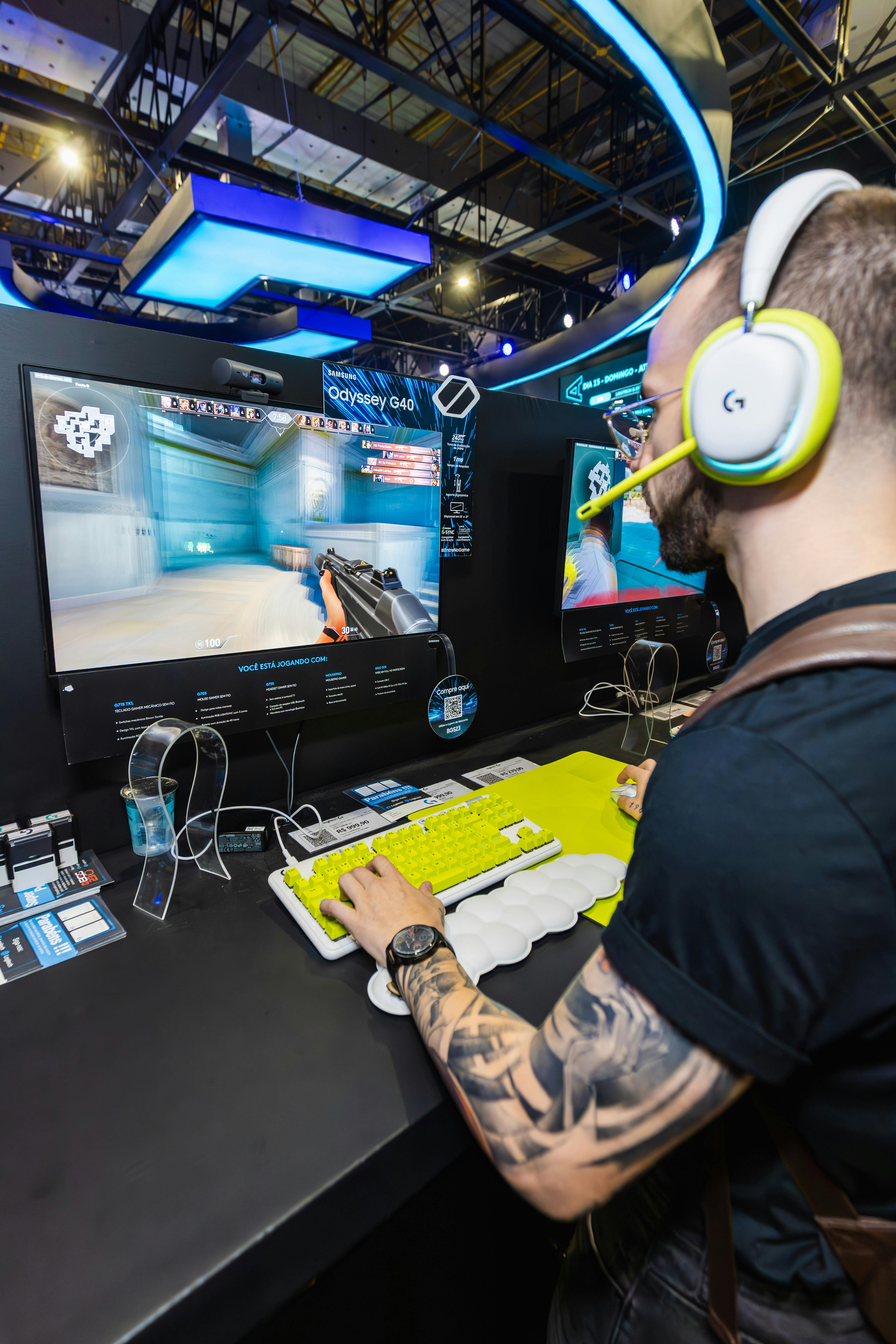 man gaming on white and yellow logitech peripherals