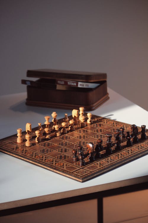 Wooden Chessboard and Chess Pieces Set up to Play