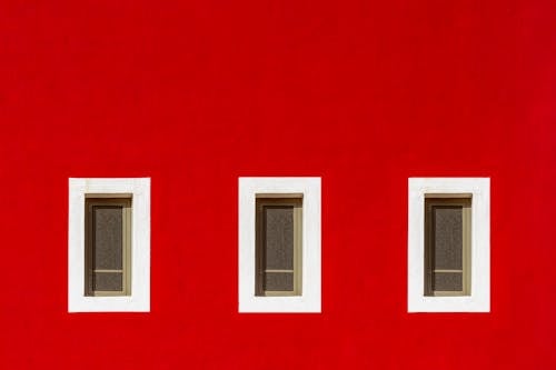 Windows with White Frames on Red Wall