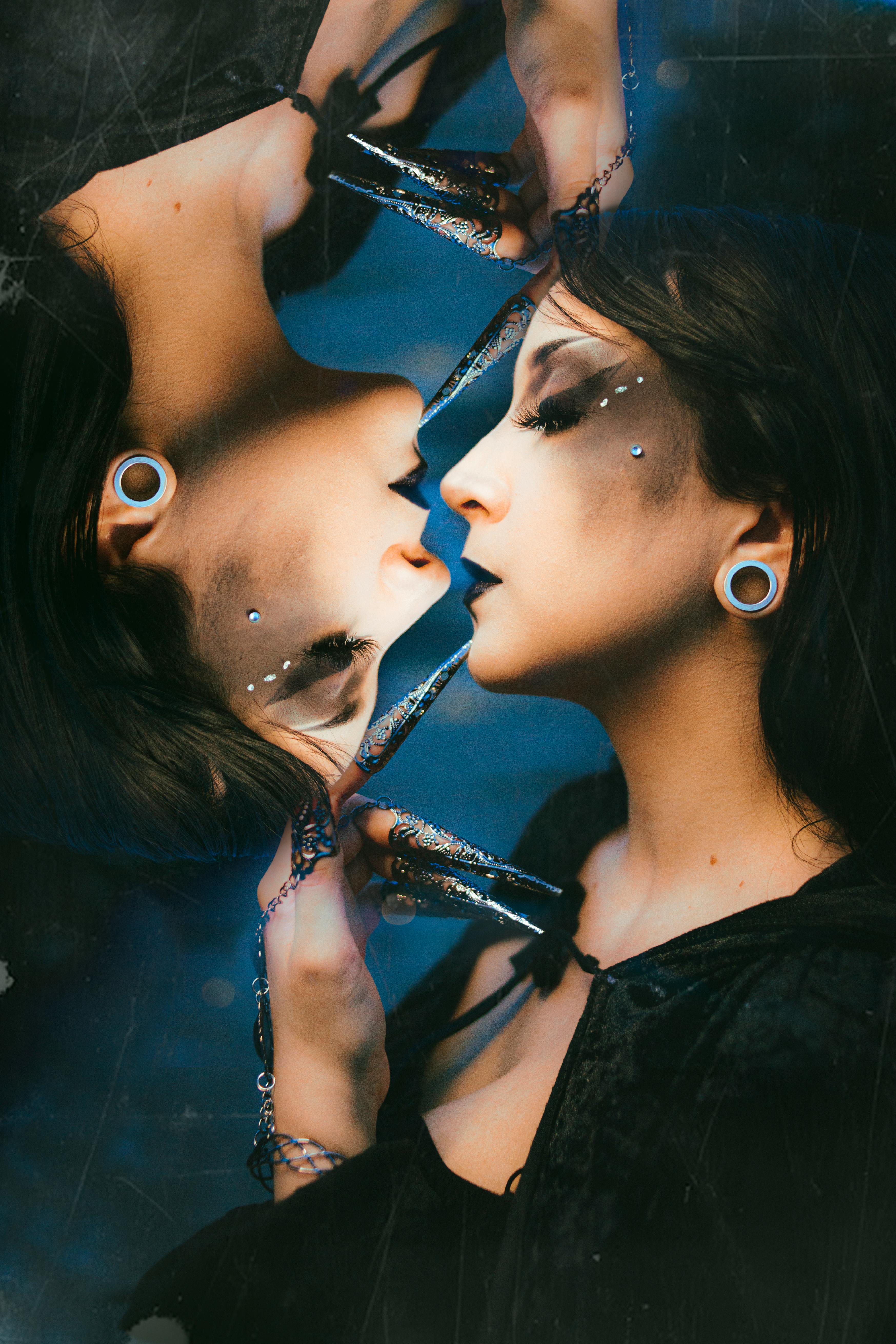 Double exposure of a woman in artistic makeup reflecting in a mirror, exuding glamour and sophistication.