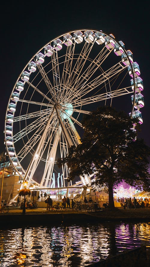Illuminated Ferris Wheel in an Amusement Park at Night