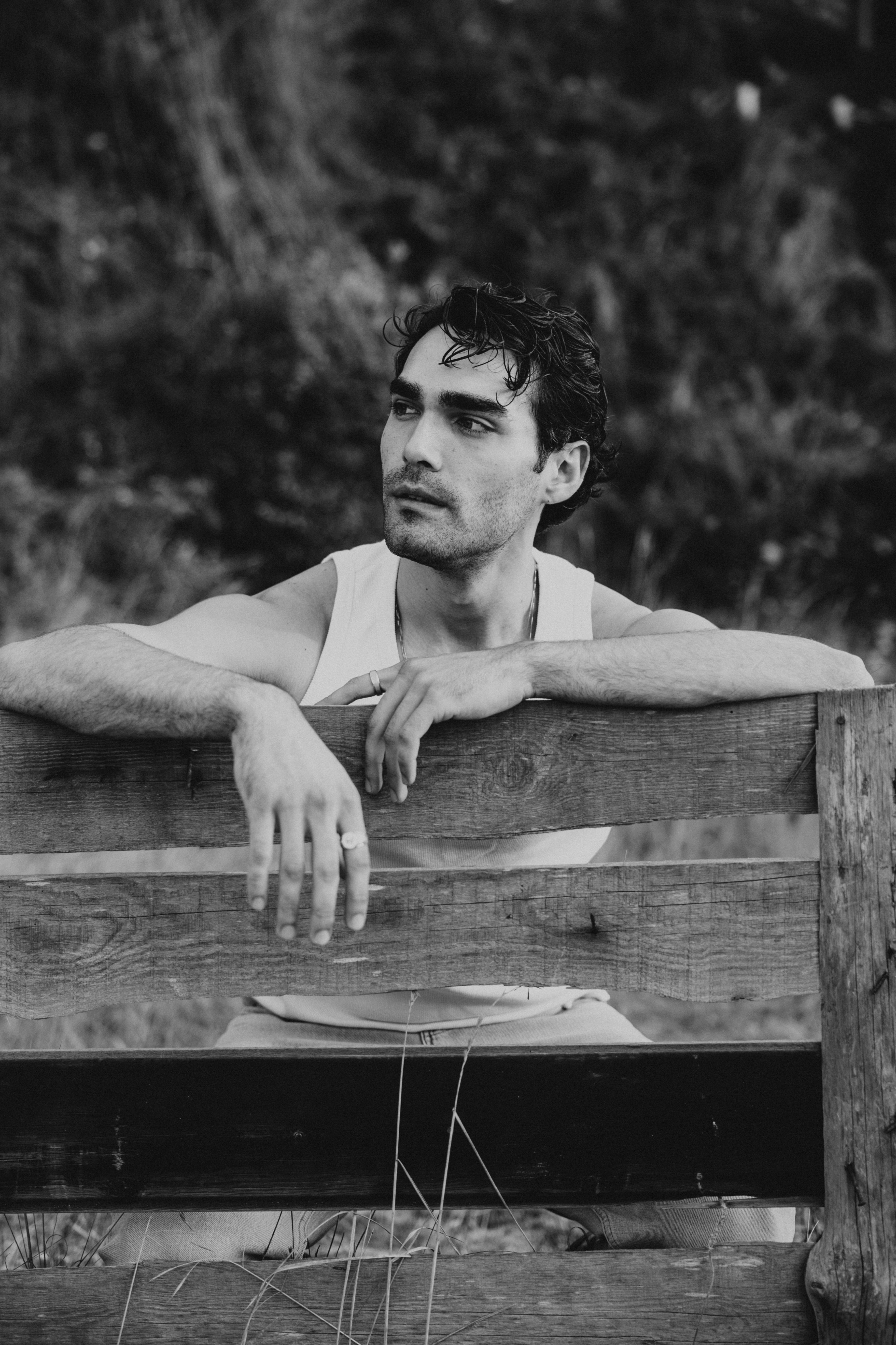 a man sitting on a bench in the woods