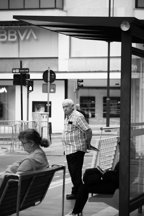 Elderly Man in Shirt Waiting at Bus Stop