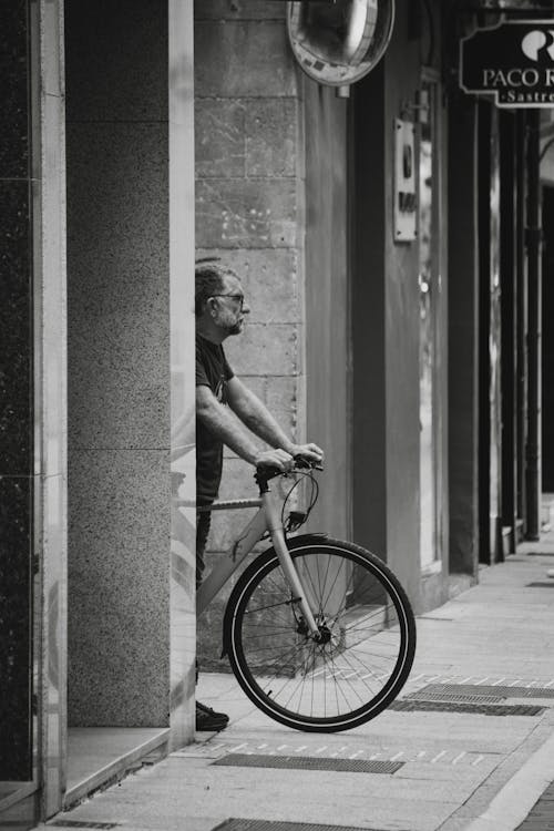 Cyclist Standing on Sidewalk