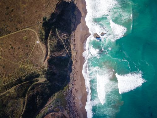 Free Stunning aerial view of Manchester, CA coastline highlighting waves and rugged cliffs. Stock Photo