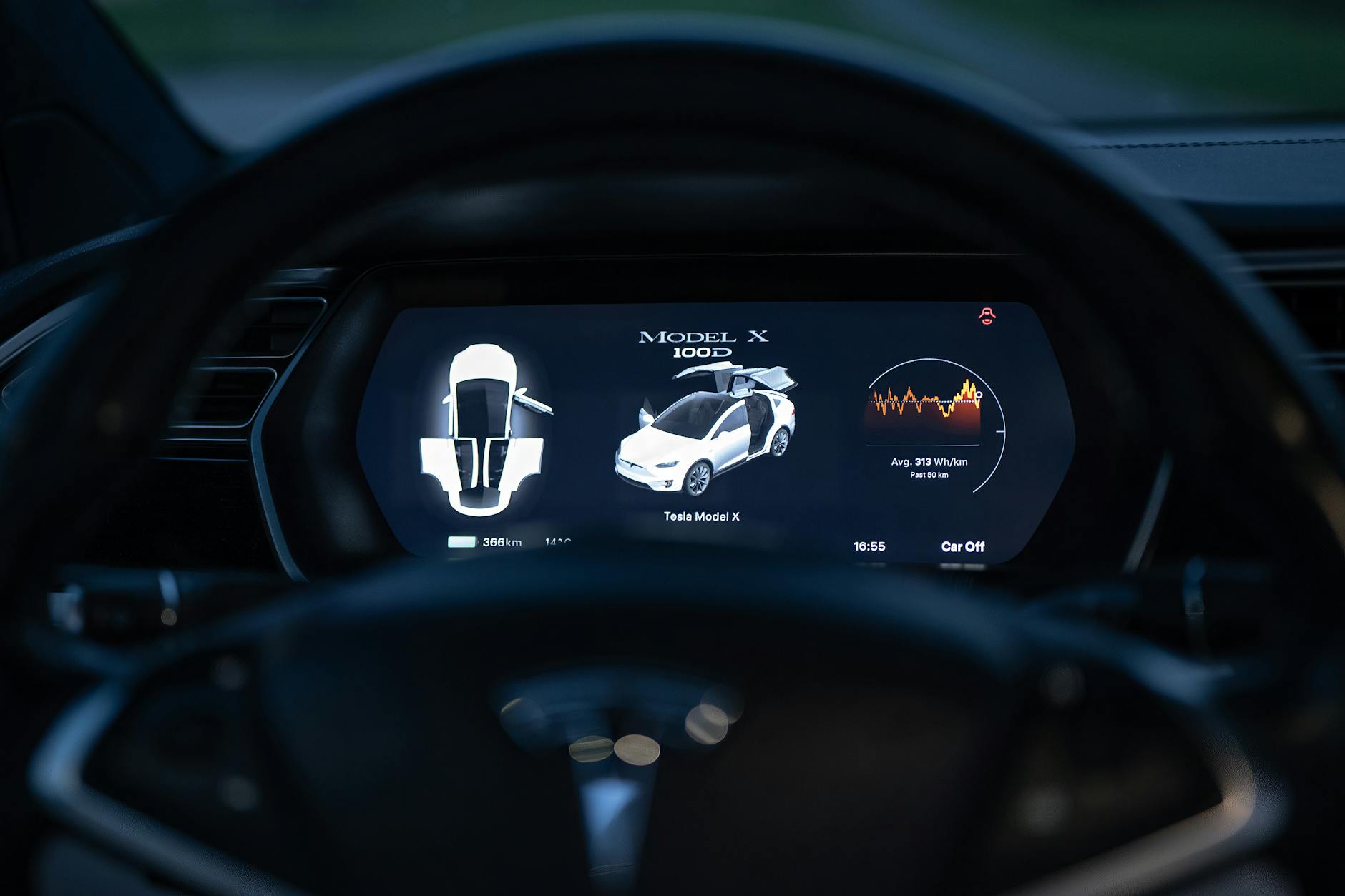 Close-up view of a Tesla Model X dashboard showcasing its digital display and futuristic controls.