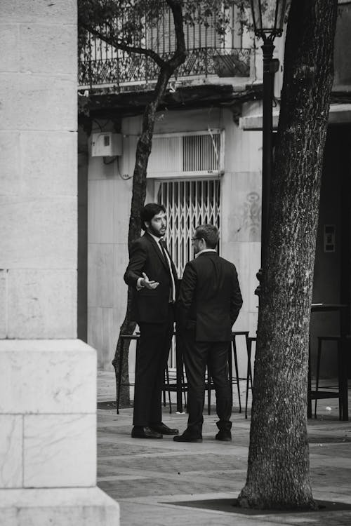 Elegant Men Talking in Alley
