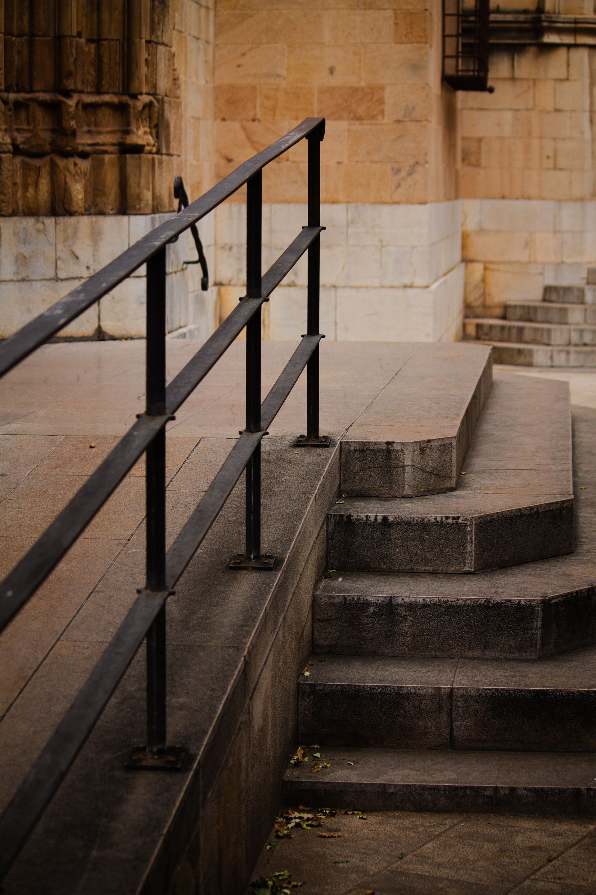 Stone steps and a metal railing at the entrance of an older building, illustrating physical accessibility at heritage and listed sites
