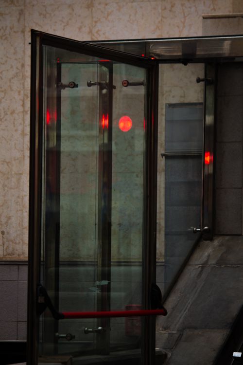 Modern glass entrance door with a metal handle