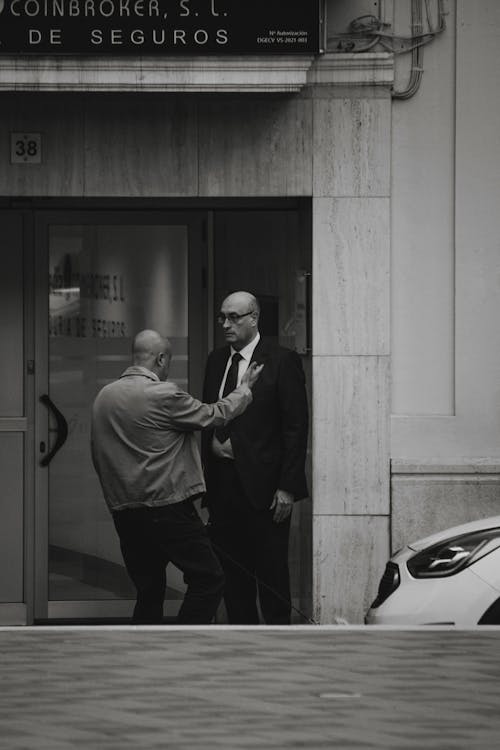 Two Men Talking in the Entrance to a Building 