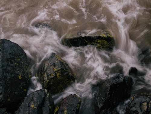 Water Flowing between Rocks Photographed in Long Exposure 