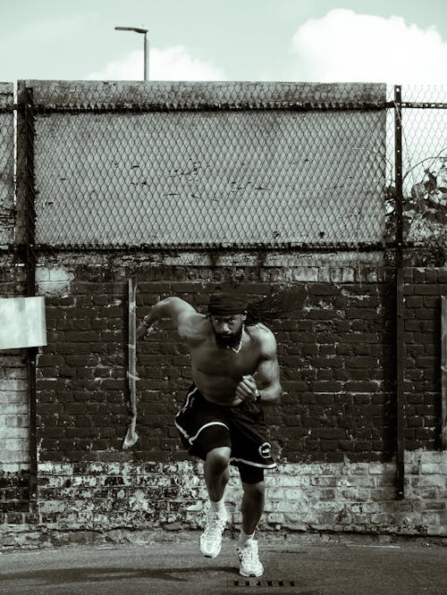 African Man Practising on a Field in Black and White 