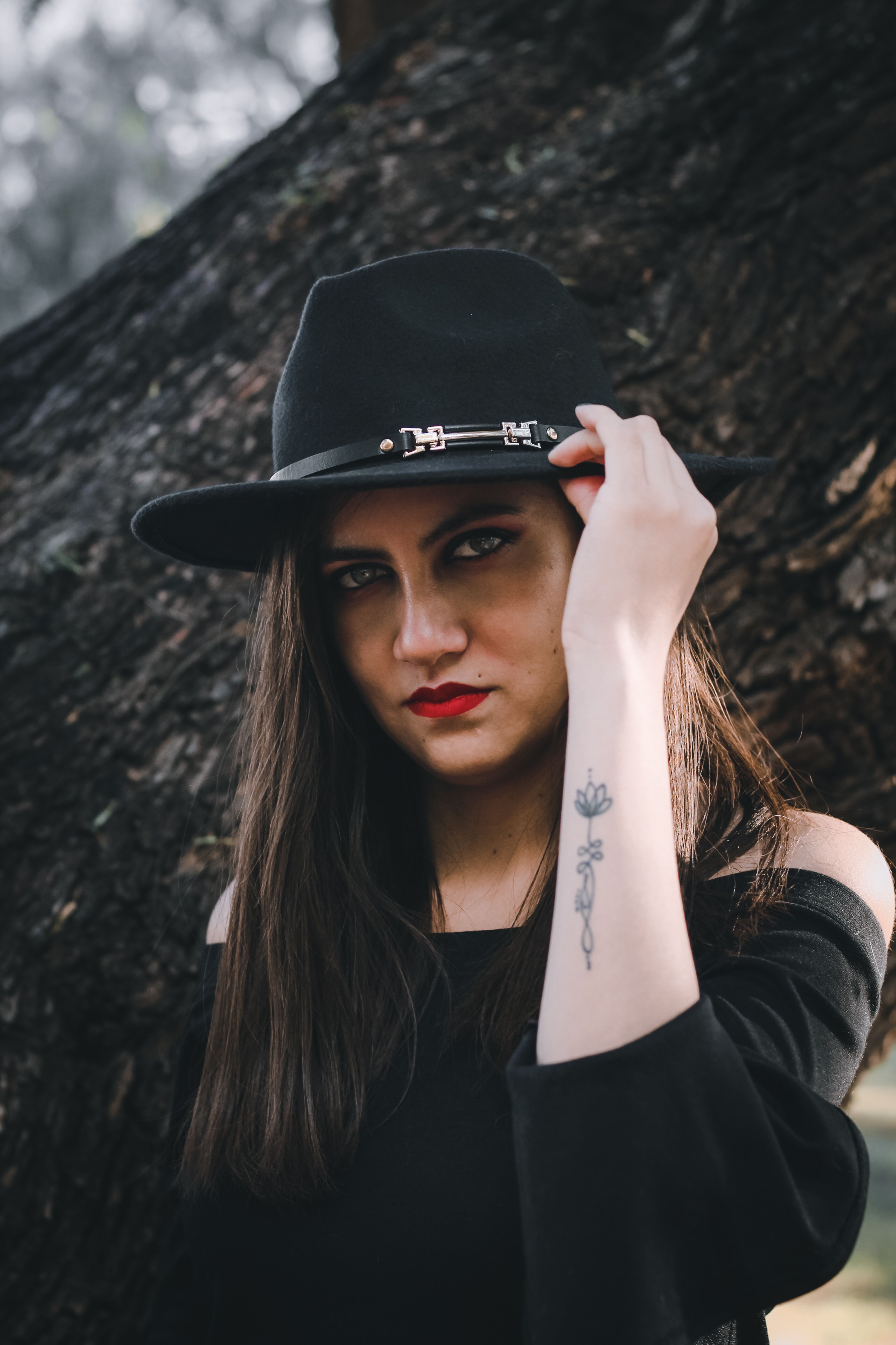 Portrait of a Long-Haired Brunette Wearing a Fedora · Free Stock Photo