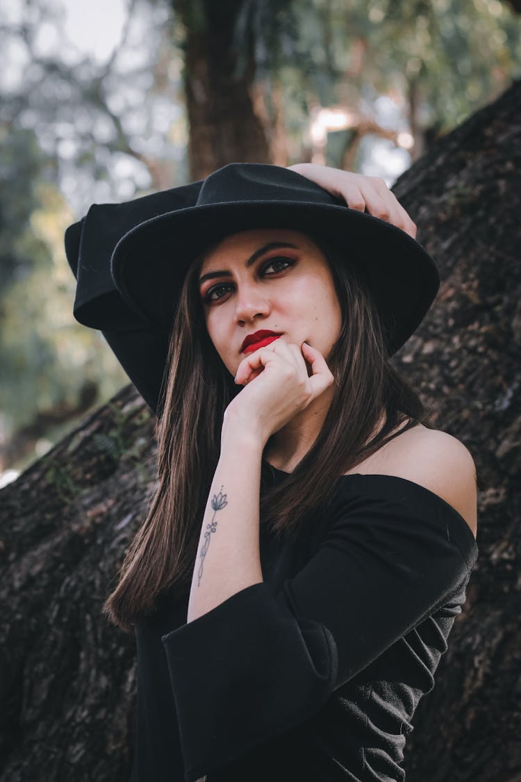 Portrait Of Woman Wearing Black Hat In A Forest 