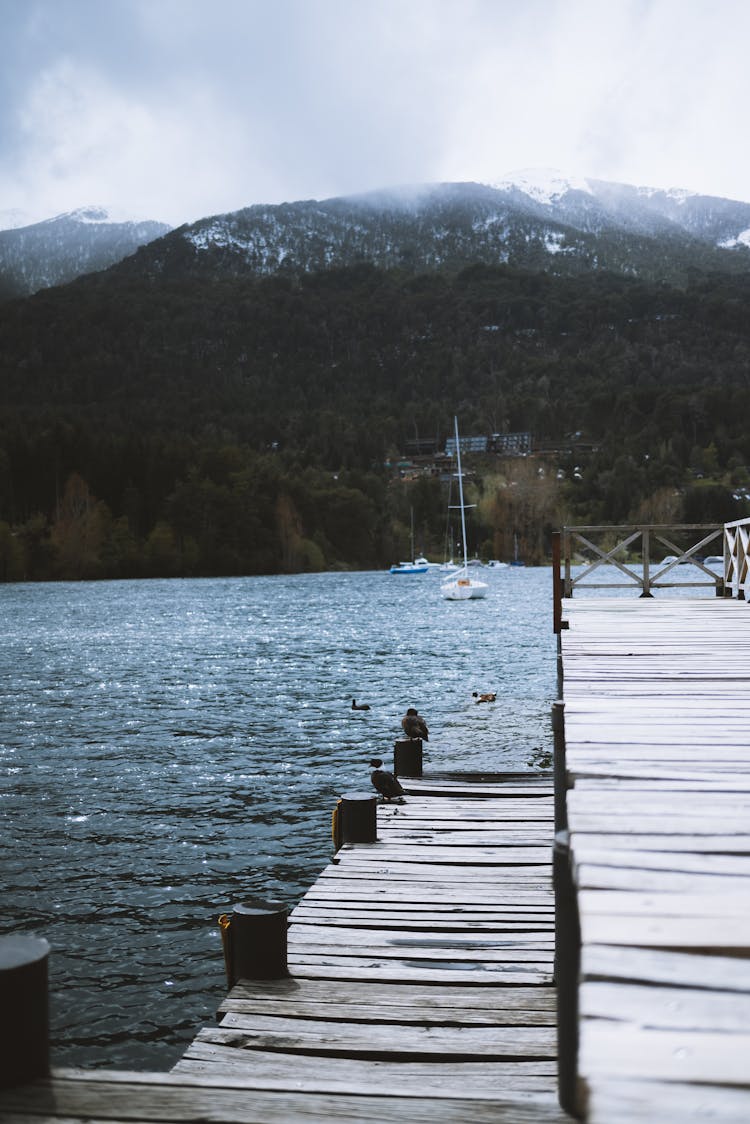 Wooden Pier By The Lake In A Mountain Valley 