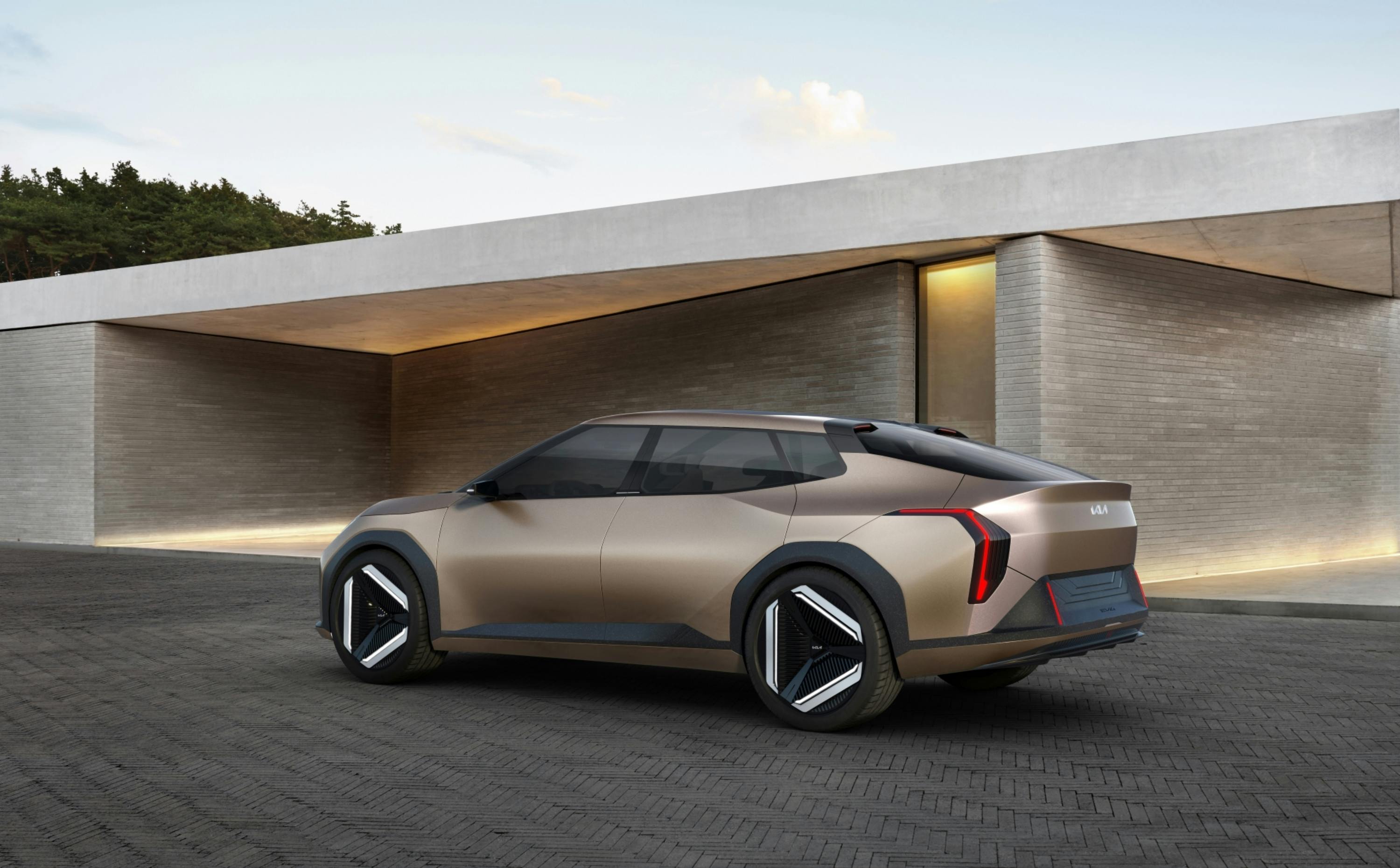 Sleek Kia concept electric vehicle parked in a modern architectural setting, showcasing design innovation.